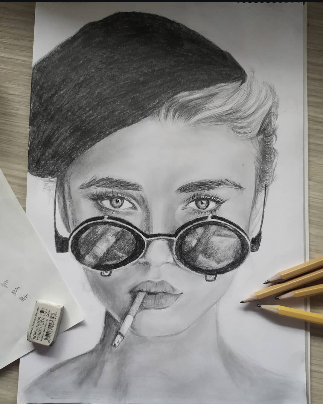 Portrait of woman with sunglasses and a cigarette, graphite on white paper